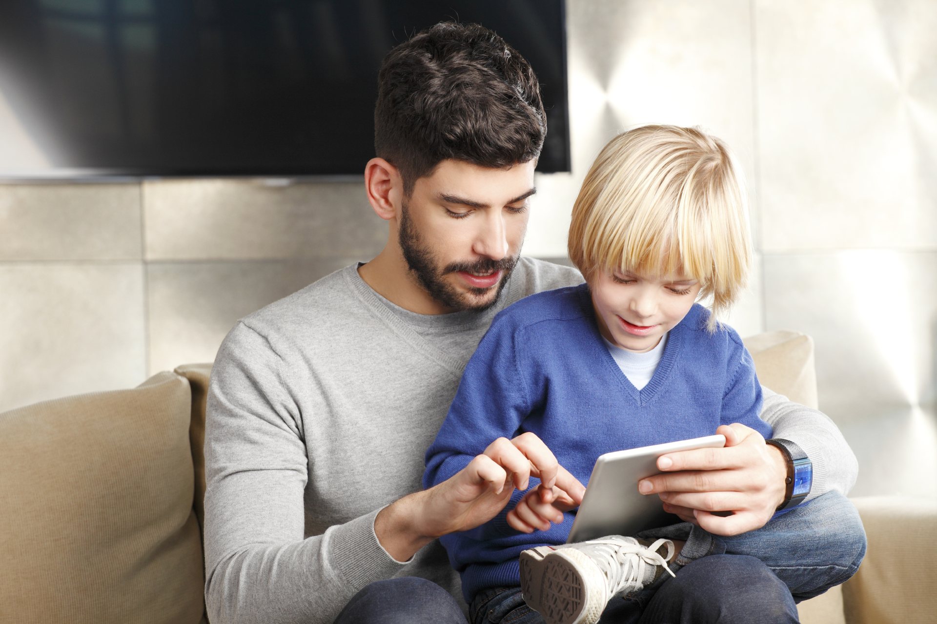 Father and son using a tablet at home